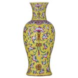 A Chinese yellow ground baluster vase, famille rose decorated with peaches, bats and stylised Shou s