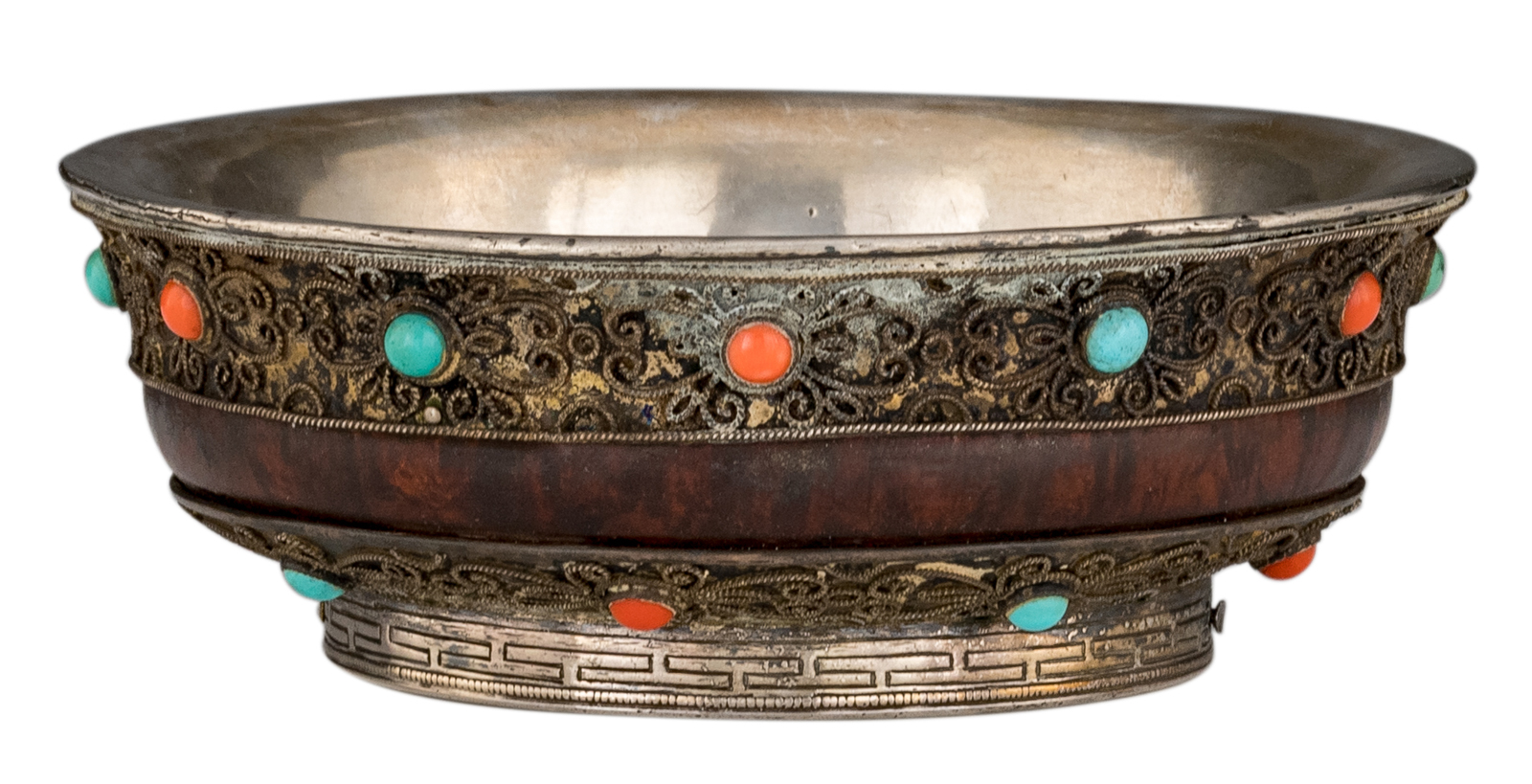 A Sino-Tibetan silver and wooden tsampa bowl, inlaid with coral and turquoise stones, the bottom rim
