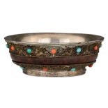 A Sino-Tibetan silver and wooden tsampa bowl, inlaid with coral and turquoise stones, the bottom rim