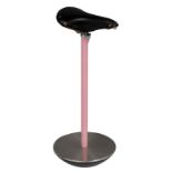 A vintage 'Stella' stool, with a black 'Brooks' saddle of a racing bicycle on a pink lacquered steel