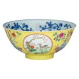 A Chinese yellow ground incised and famille rose bowl, decorated with antiquities, flowers and goats