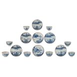 Five Chinese blue and white cups and saucers, decorated with a pavilion in a mountainous landscape;