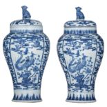 A pair of Chinese blue and white vases and covers, decorated with birds and flowers, 19thC, H 43 cm