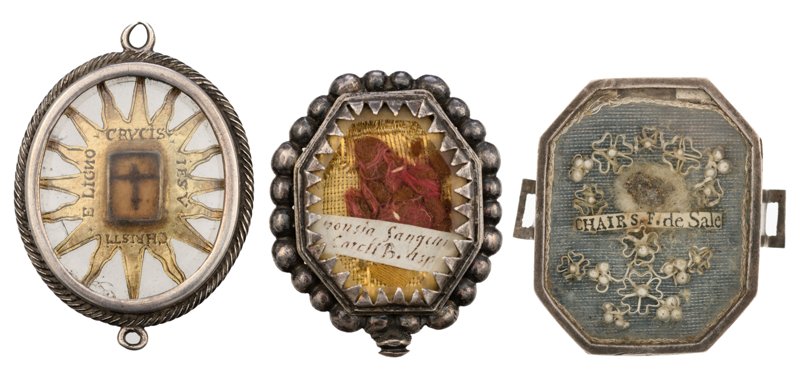 Three 17th / 18thC devotional reliquary pendants with relics of the Holy Cross, St. Francis of Sales