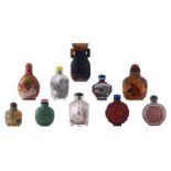 A collection of nine Chinese various snuff bottles; added a ditto miniature carved jade relief decor