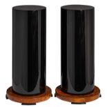 A decorative pair of black lacquered columns on a burl veneered base, H 83 cm