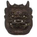 A Japanese bronze devil mask, H 22,5 - W 18,5 - D 7,5 cm
