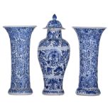 A pair of Chinese blue and white floral relief decorated cylindrical Kangxi vases; added a ditto bal