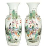 A pair of Chinese famille rose vases, decorated with an animated scene, 19thC, H 57,5 cm