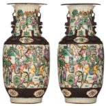 A pair of Chinese famille verte and famille rose relief decorated stoneware vases with warrior scene