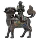 A Chinese champlevé enamel bronze figure, depicting a Guanyin, seated on a Fu lion, marked, 19th/20t