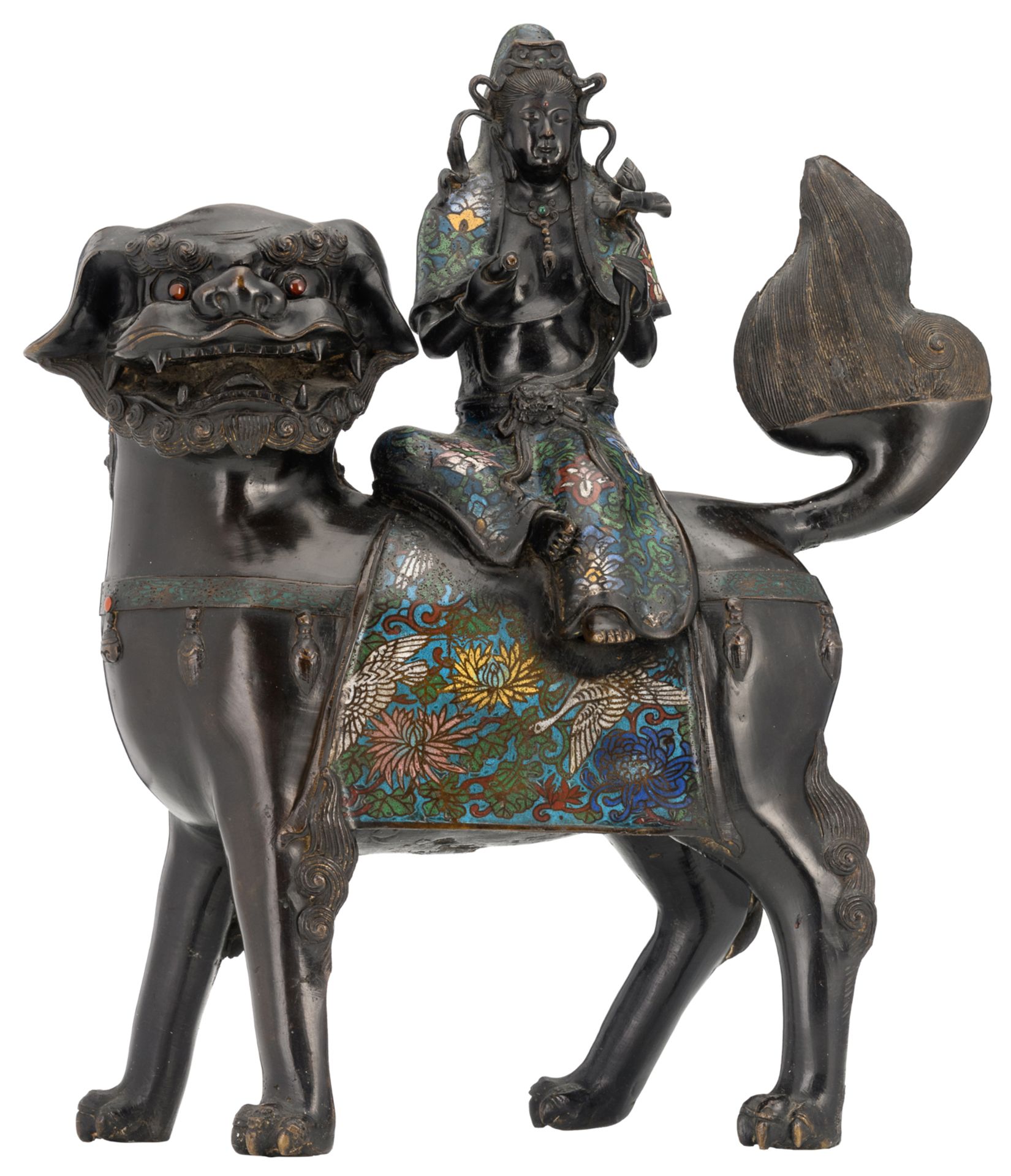 A Chinese champlevé enamel bronze figure, depicting a Guanyin, seated on a Fu lion, marked, 19th/20t