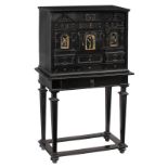 A probably Italian Baroque ebonised cabinet on stand, decorated with architectural ornaments and égl