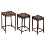 A set of three Chinese hardwood occasional tables, with mother-of pearlinlaid decoration depicting l