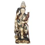 A Chinese polychrome painted ivory seated Guanyin figure accompanied by a Fô-lion, late Qing-period,