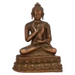 A lost-wax process cast red copper Amoghasiddhi Buddha, possibly 16th - 17thC, with a natural patina