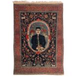 An Oriental woollen rug, decorated with a male figure in a medallion, surrounded by floral motifs an