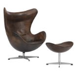 A brown leather upholstered 'Egg chair' and a matching ottoman, design by Arne Jacobsen for the Repu