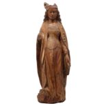 An oak sculpture of a female Saint, with traces of polychrome paint, 16th/17thC, probably French, H