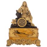 A yellow Sienna mantel clock, with patinated and gilt bronze decoration and on top a well-read noble