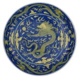 A Chinese cobalt blue underglaze and yellow upper glaze dragon plate, decorated with the five-clawed