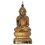 An Oriental wooden gilt decorated seated figure of a Buddha, H 69 - W 29,5 - D 21,5