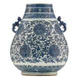 A Chinese blue and white archaistic hu-vase, the pear-shaped body densely decorated with lotus scrol