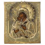A 19thC Eastern European icon depicting the Holy Mother and Child with a gilt oklad, 31 x 27 cm
