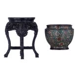 An Oriental floral decorated champlevé enamel bronze jardinière; added a Chinese richly carved hardw