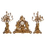 A very fine and imposing Rococo style three-piece mantle clock garniture, decorated with putti holdi