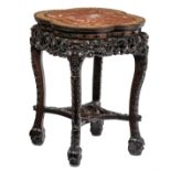 A Chinese exotic hardwood base, richly carved with dragons, the top with floral mother-of-pearl inla