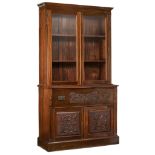 A Victorian mahogany secrétaire bookcase, decorated with bas-relief carved scrollwork, the top drawe