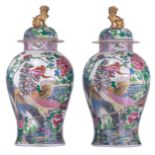 A large pair of covered famille rose Samson vases, decorated with birds and griffons in a floral set