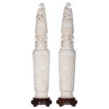 A pair of Chinese Canton sculpted ivory display vases, the front roundels decorated with garden scen