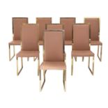 A set of eight vintage polished brass dining chairs with a salmon rouge leather upholstery, in the m