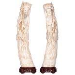 A pair of Chinese Canton ivory statues depicting a fisherman and his wife, with delicate stained eng