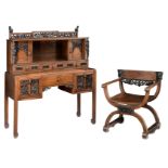 A Chinese exotic hardwood writing desk and armchair, richly carved with flower baskets, dragons and