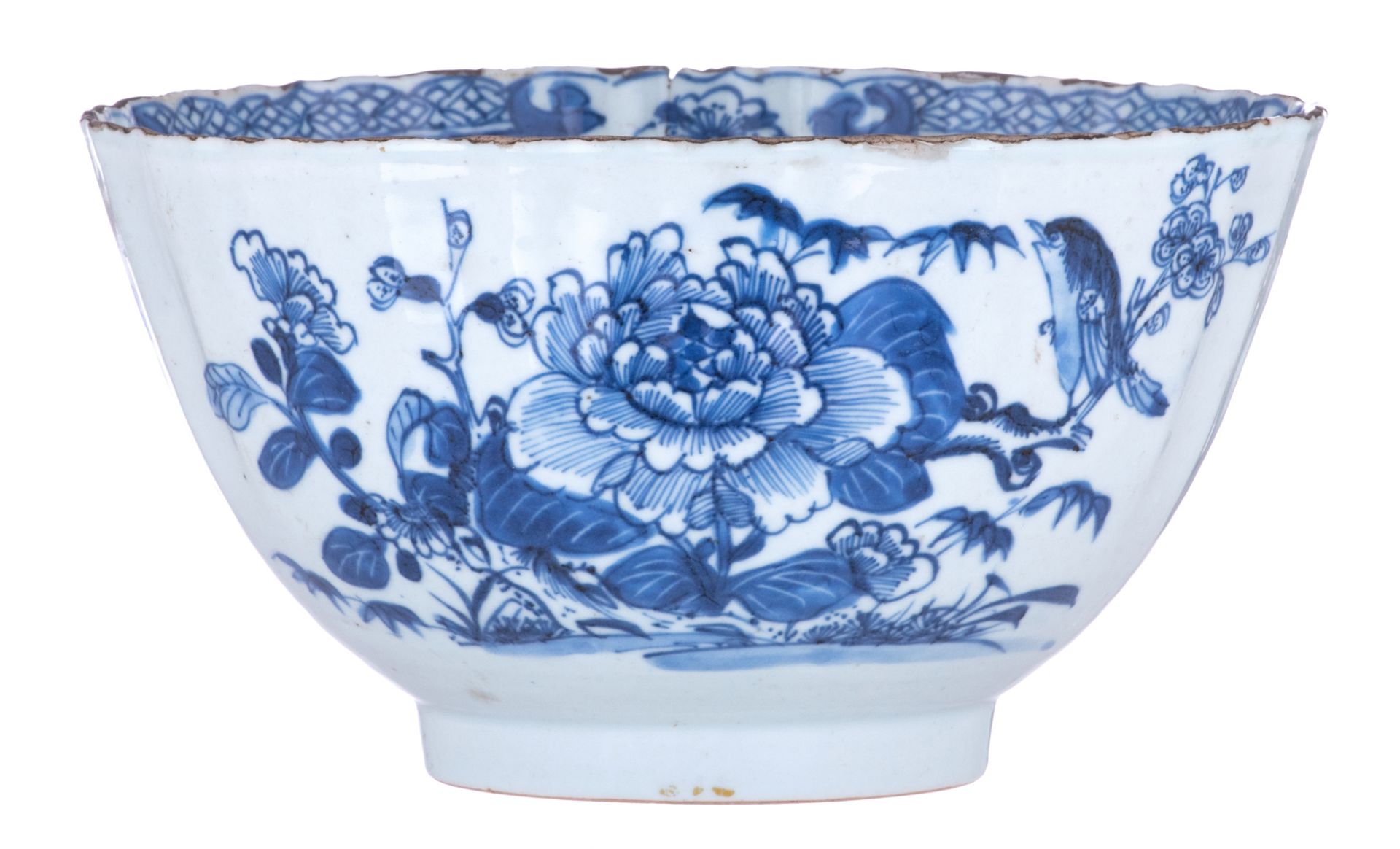 A Chinese blue and white lobed bowl, the front and reverse decorated with a bird and peony branches,