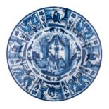 A blue and white decorated Wanli style Dutch Delftware charger, decorated with figures in a garden s