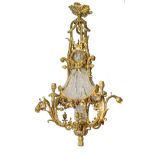 An imposing Neoclassical gilt bronze chandelier, the central glass bowl overarched by cut glass pear