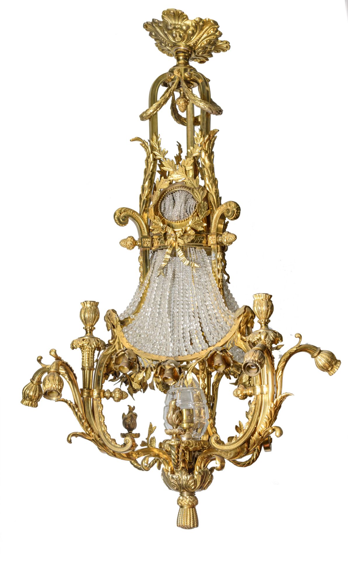 An imposing Neoclassical gilt bronze chandelier, the central glass bowl overarched by cut glass pear