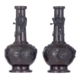 A pair of East Asian patinated bronze vases, relief decorated with a dragon and birds sitting on bra