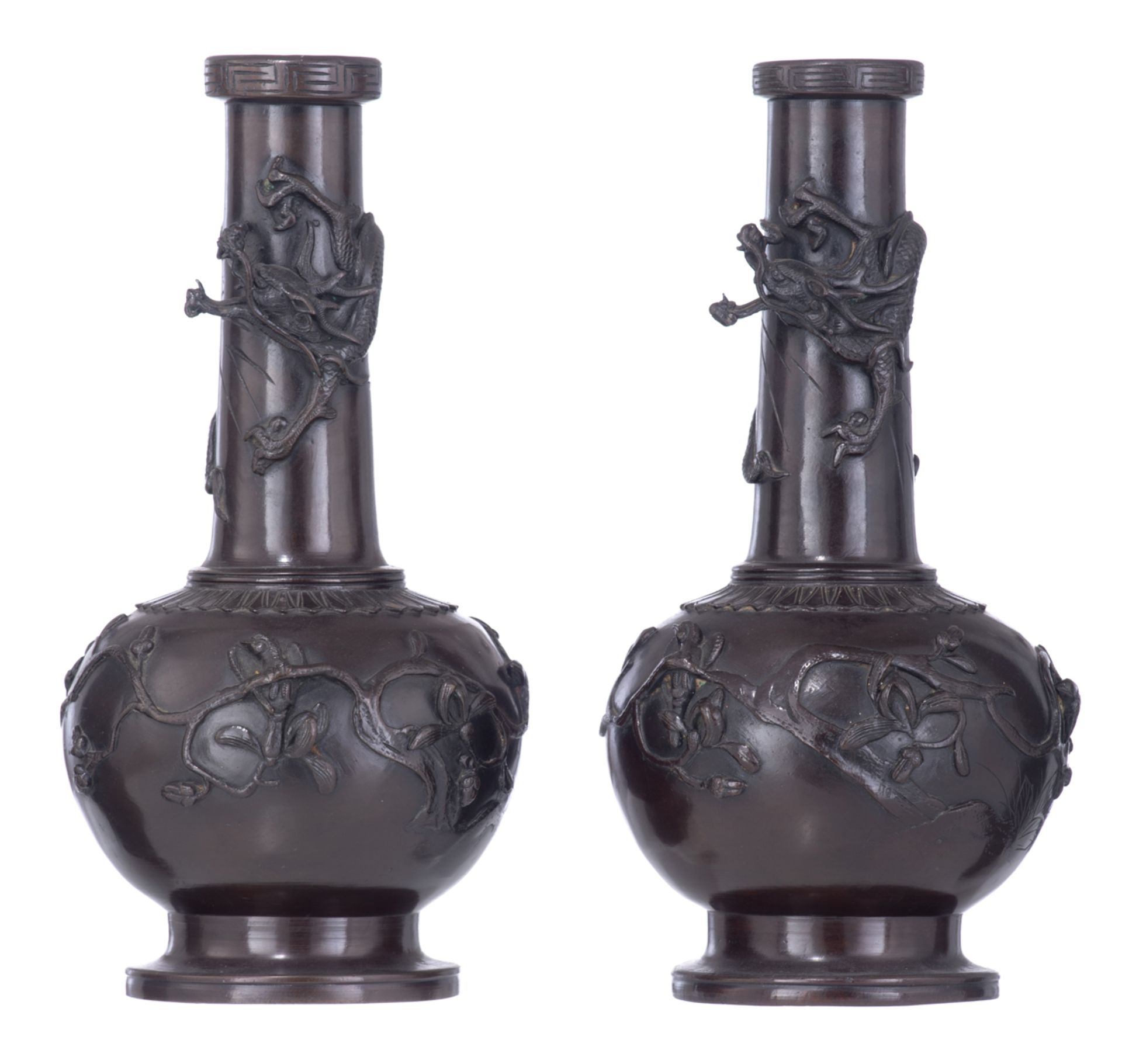 A pair of East Asian patinated bronze vases, relief decorated with a dragon and birds sitting on bra