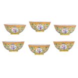 Six Chinese yellow ground famille rose floral decorated bowls, the panels with flower vases, the ins