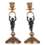 A pair of French mid-19thC gilt and patinated bronze candlesticks, the stems shaped as caryatid cher