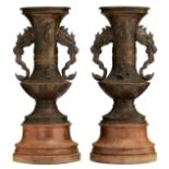 A pair of Oriental relief bronze vases, the panels floral decorated with a deer, a crane, figures an