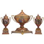 A fine Viennese three-piece burgundy ground and polychrome and gilt decorated soft porcelain garnitu