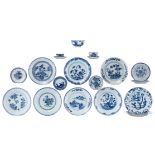 A various lot of Chinese blue and white decorated dishes, deep dishes, cups and saucers, decorated w