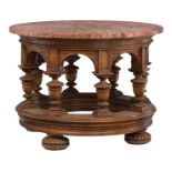 A circular Renaissance style walnut coffee table, the rouge imperial marble top supported by eight l