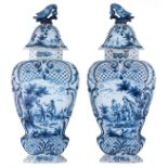 A large pair of blue and white and relief decorated Dutch Delftware covered vases, with bird-shaped